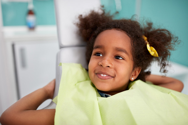 Adorable smiling girl in dental chair in Arlington, WA office.