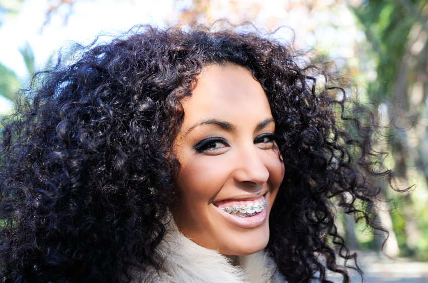Image of a smiling adult woman with braces on.